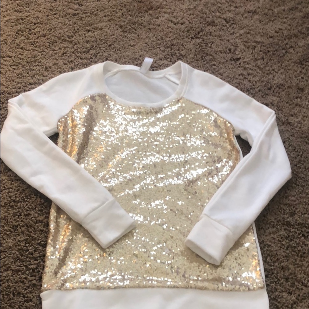 White long sleeve with golden sparkles.